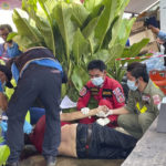 
              First responders attend to a victim at the site of an attack at a day care center, Thursday, Oct. 6, 2022, in the town of Nongbua Lamphu, north eastern Thailand. A former policeman facing a drug charge burst into a day care center in northeastern Thailand on Thursday, killing dozens of preschoolers and teachers before shooting more people as he fled in the deadliest rampage in the nation’s history. (Mungkorn Sriboonreung Rescue Group via AP)
            