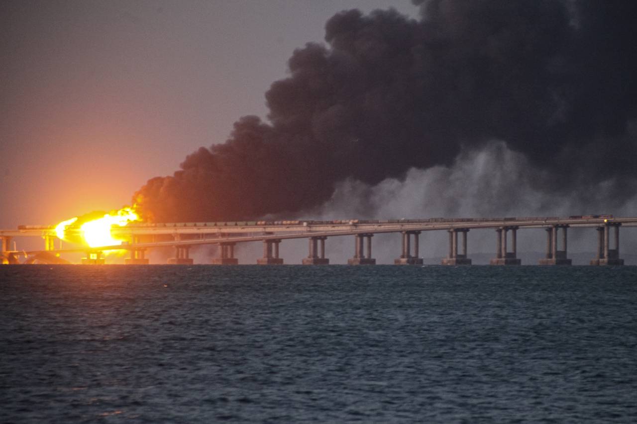 Flame and smoke rise fron Crimean Bridge connecting Russian mainland and Crimean peninsula over the...