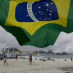 
              A Brazlian flag waves in the breeze on Copacabana Beach during general elections, in Rio de Janeiro, Brazil, Sunday, Oct. 2, 2022. (AP Photo/Bruna Prado)
            