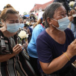 
              Relatives pray during a ceremony for those killed in the attack on the Young Children's Development Center in the rural town of Uthai Sawan, north eastern Thailand, Friday, Oct. 7, 2022. A former policeman facing a drug charge burst into a day care center in northeastern Thailand on Thursday, killing dozens of preschoolers and teachers before shooting more people as he fled in the deadliest rampage in the nation's history. (AP Photo/Sakchai Lalit)
            