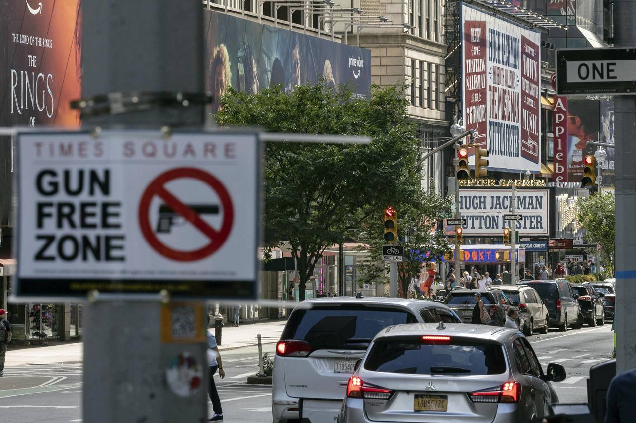 FILE— A sign reading "Gun Free Zone" is posted near around Times Square, Aug. 31, 2022, in New Yo...