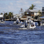 
              FILE - Boats operated by resident good Samaritans help evacuate residents who stayed behind on Pine Island, in the aftermath of Hurricane Ian in Matlacha Fla., Sunday, Oct. 2, 2022. The only bridge to the island is heavily damaged so it can only be reached by boat or air. The devastation from Hurricane Ian has left schools shuttered indefinitely in parts of Florida, leaving storm-weary families anxious for word on when and how children can get back to classrooms. (AP Photo/Gerald Herbert, File)
            