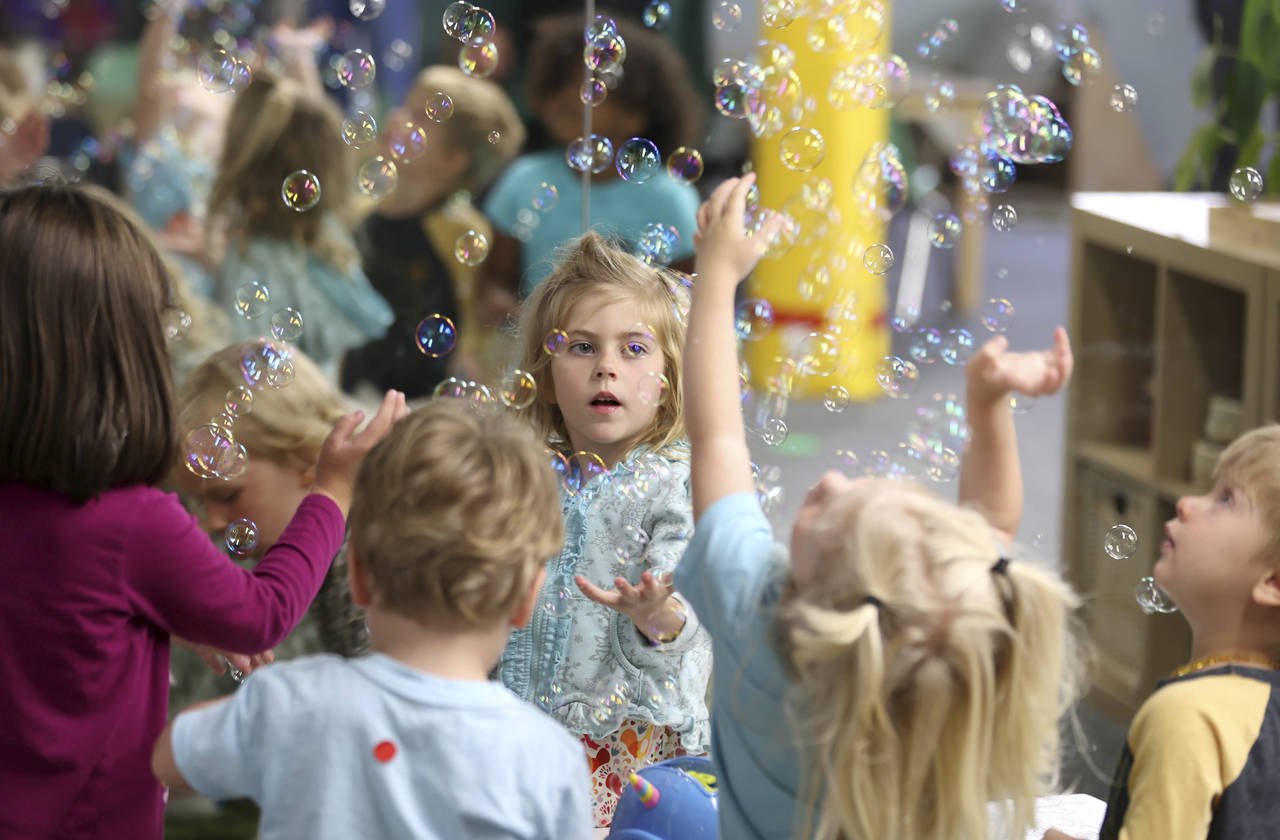 Lova Robinson, 4, plays with bubbles at the Bumble Art Studio day care in Astoria, Ore., Friday, Se...