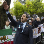 
              Protesters demonstrate during the global protest against the Iranian regime in front of the Iranian embassy in Bern, Switzerland, Saturday, Oct. 1, 2022. They protest against the death of Mahsa Amini, a woman who died while in police custody in Iran. Mahsa Amini was arrested by Iran's morality police for allegedly violating its strictly-enforced dress code. (Peter Klaunzer/Keystone via AP)
            