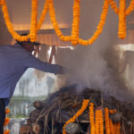 
              Partner Jim Morrison performs rituals during the funeral of famed American extreme skier Hilaree Nelson in Kathmandu, Nepal, Sunday, Oct.2, 2022. Nelson had died last week on Mount Manaslu while coming down from the top of the summit the 8,163-meter (26,775-foot) world's eighth-highest mountain. (AP Photo/Niranjan Shrestha)
            