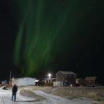 
              The northern lights appear over Shishmaref, Alaska, Sunday, Oct. 2, 2022. Rising sea levels, flooding, increased erosion and loss of protective sea ice and land have led residents of this island community to vote twice to relocate. But more than six years after the last vote, Shishmaref remains in the same place because the relocation is too costly. (AP Photo/Jae C. Hong)
            