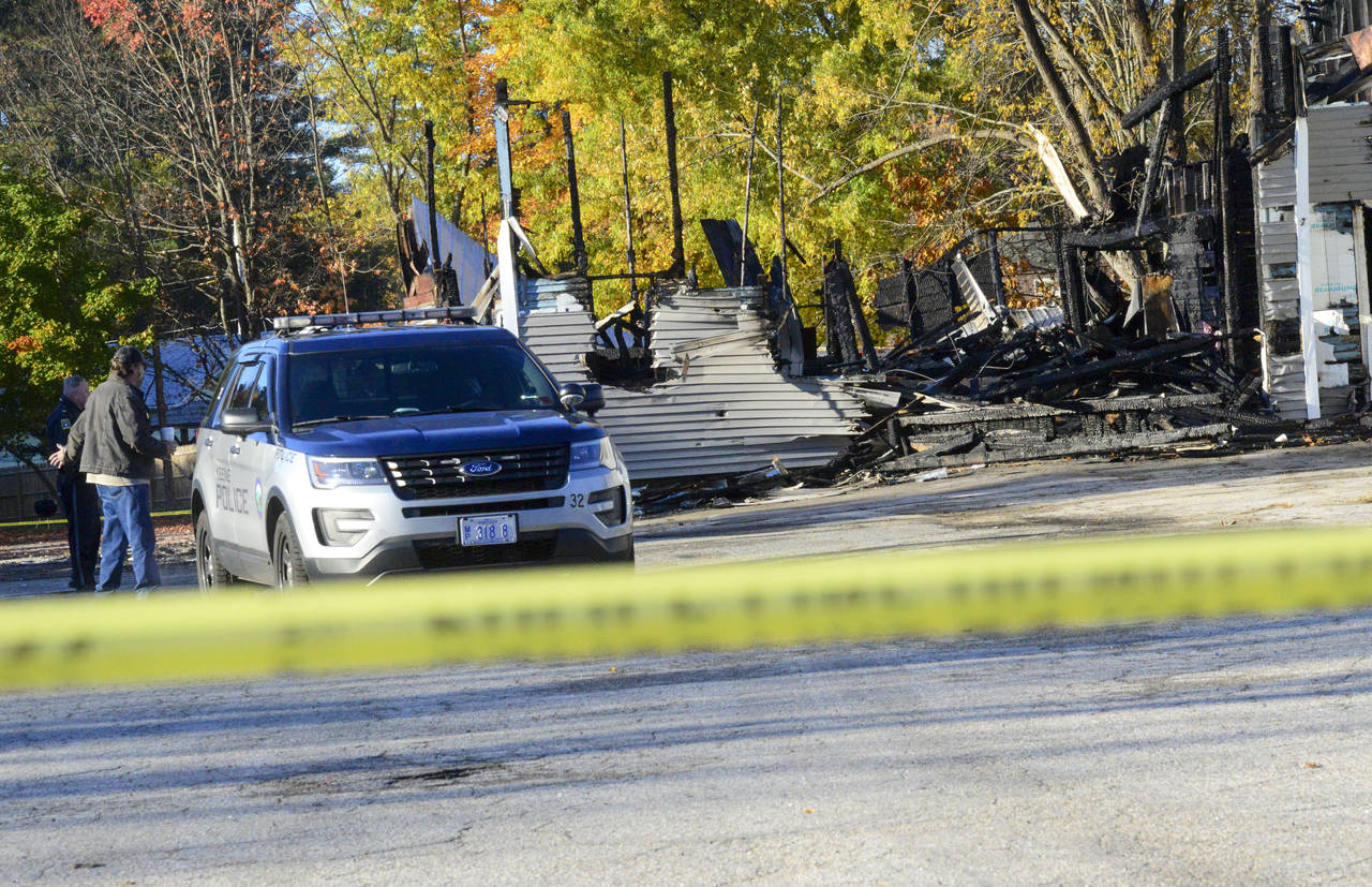 Investigators examine the site of a plane crash in Keene, N.H. on Saturday, Oct. 22, 2022. The Fede...
