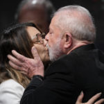 
              Former Brazilian President Luiz Inacio Lula da Silva, who is running for president again, kisses his wife Rosangela Silva after general election polls closed in in Sao Paulo, Brazil, Sunday, Oct. 2, 2022. (AP Photo/Andre Penner)
            