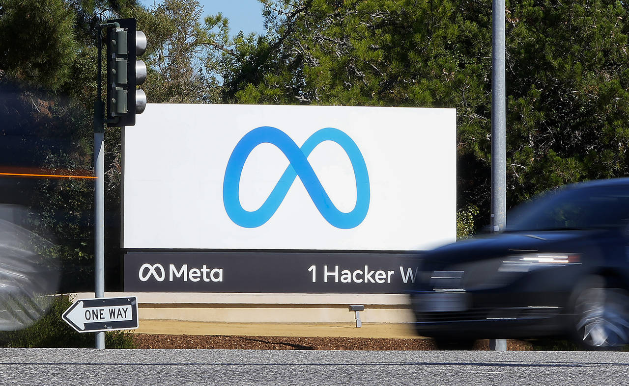 FILE - A car passes Facebook's new Meta logo on a sign at the company headquarters on Oct. 28, 2021...