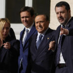 
              Forza Italia president Silvio Berlusconi, center, poses with Brothers of Italy's leader Giorgia Meloni and The League leader Matteo Salvini, and center-right party members as they leave the Quirinale Presidential Palace after a meeting with Italian President Sergio Mattarella as part of a round of consultations with party leaders to try and form a new government, in Rome, Friday, Oct. 21, 2022. (AP Photo/Alessandra Tarantino)
            