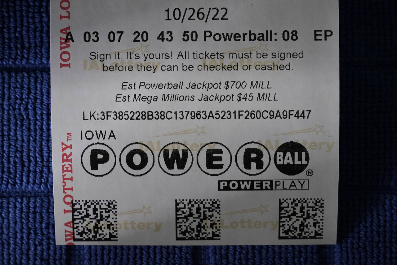 A Powerball ticket showing the estimated jackpot of $700 million is displayed, Tuesday, Oct. 25, 20...