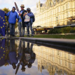 
              Protestors are reflected in a puddle opposite parliament after Britain's Prime Minister Liz Truss resigned in London, Thursday, Oct. 20, 2022. Truss resigned Thursday, bowing to the inevitable after a tumultuous, short-lived term in which her policies triggered turmoil in financial markets and a rebellion in her party that obliterated her authority.(AP Photo/Alberto Pezzali)
            