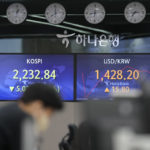 
              A currency trader works near the screens showing the Korea Composite Stock Price Index (KOSPI), left, and the foreign exchange rate between U.S. dollar and South Korean won at a foreign exchange dealing room in Seoul, South Korea, Tuesday, Oct. 11, 2022. Asian shares were mostly lower on Tuesday as losses in technology-related shares weighed on global benchmarks. (AP Photo/Lee Jin-man)
            