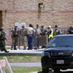 
              FILE - Law enforcement, and other first responders, gather outside Robb Elementary School following a shooting, May 24, 2022, in Uvalde, Texas. Four months after the Robb Elementary School shooting, the Uvalde school district on Friday, Oct. 7 pulled its entire embattled campus police force off the job following a wave of new outrage over the hiring of a former Texas state trooper who was part of the hesitant law enforcement response as a gunman killed 19 children and two teachers. (AP Photo/Dario Lopez-Mills, File)
            