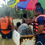 
              In this photo provided by the Philippine Coast Guard, rescuers use an old refrigerator as a float as they evacuate residents from flood waters caused by Tropical Storm Nalgae in Hilongos, Leyte province, Philippines on Friday Oct. 28, 2022. Flash floods and landslides set off by torrential rains left dozens of people dead, including in a hard-hit southern Philippine province, where many villagers are feared missing and buried in a deluge of rainwater, mud, rocks and trees, officials said Saturday. (Philippine Coast Guard via AP)
            