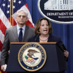 
              Deputy Attorney General Lisa Monaco, center, joined at left by Attorney General Merrick Garland, speaks to reporters as they announce charges against two men suspected of being Chinese intelligence officers for attempting to obstruct a U.S. criminal investigation and prosecution of Chinese tech giant Huawei, at the Department of Justice in Washington, Monday, Oct. 23, 2022. (AP Photo/J. Scott Applewhite)
            