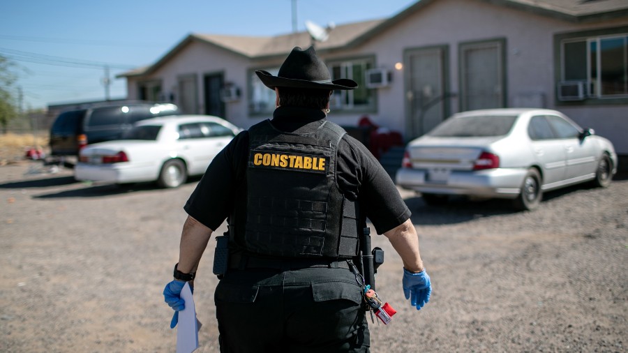 Maricopa County constable Darlene Martinez arrives to a home to post an eviction order on October 1...