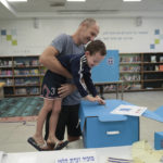 
              A man and his son vote during Israeli elections in Tel Aviv, Israel, Tuesday, Nov 1, 2022. (AP Photo/Oded Balilty)
            