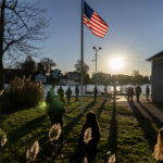 
              Voters line up to cast their ballots in the midterm election at the Aspray Boat House in Warwick, R.I., Tuesday, Nov. 8, 2022. (AP Photo/David Goldman)
            