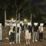 
              CORRECTS THE PLACE TO CHINESE UNIVERSITY OF HONG KONG  - Protesters hold up blank white papers during a commemoration for victims of a recent Urumqi deadly fire, at the Chinese University of Hong Kong in Hong Kong, Monday, Nov. 28, 2022. Students in Hong Kong chanted “oppose dictatorship” in a protest against China’s anti-virus controls after crowds in mainland cities called for President Xi Jinping to resign in the biggest show of opposition to the ruling Communist Party in decades. (AP Photo/Kanis Leung)
            