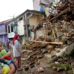 
              Residents inspect houses damaged by Monday's earthquake in Cianjur, West Java, Indonesia Tuesday, Nov. 22, 2022. The earthquake has toppled buildings on Indonesia's densely populated main island, killing a number of people and injuring hundreds. (AP Photo/Rangga Firmansyah)
            