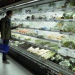 
              A resident looks at fresh produces at a supermarket in Beijing, Friday, Nov. 25, 2022. Residents of China's capital were emptying supermarket shelves and overwhelming delivery apps Friday as the city government ordered accelerated construction of COVID-19 quarantine centers and field hospitals. (AP Photo/Ng Han Guan)
            