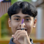 
              A young voter shows his finger with ink after casting his vote during the general election at a voting center in Alor Setar, Kedah, Malaysia, Saturday, Nov. 19, 2022. Malaysians have begun casting ballots in a tightly contested national election that will determine whether the country’s longest-ruling coalition can make a comeback after its electoral defeat four years ago. (AP Photo/JohnShen Lee)
            