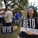 
              Bonnie Murray, a Beto O'Rourke supporter, holds a sign supporting the Texas Gubernatorial candidate for governor as he speaks to a crowd at rear during a campaign stop in Dallas, Tuesday, Nov. 8, 2022. (AP Photo/Tony Gutierrez)
            