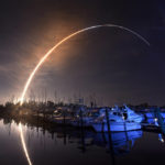 
              NASA's new moon rocket lifts off from the Kennedy Space Center in Cape Canaveral, Wednesday morning, Nov. 16, 2022, as seen from Harbor town Marina on Merritt Island, Fla. The moon is visible in the sky. (Malcolm Denemark/Florida Today via AP)
            