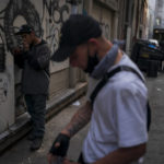 
              Two drug addicts smoke fentanyl in an alley in Los Angeles, Monday, April 18, 2022. Because it's 50 times more potent than heroin, even a small dose can be fatal. It has quickly become the deadliest drug in the nation, according to the Drug Enforcement Administration. Two-thirds of the 107,000 overdose deaths in 2021 were attributed to synthetic opioids like fentanyl, the U.S. Centers for Disease Control and Prevention says. (AP Photo/Jae C. Hong)
            