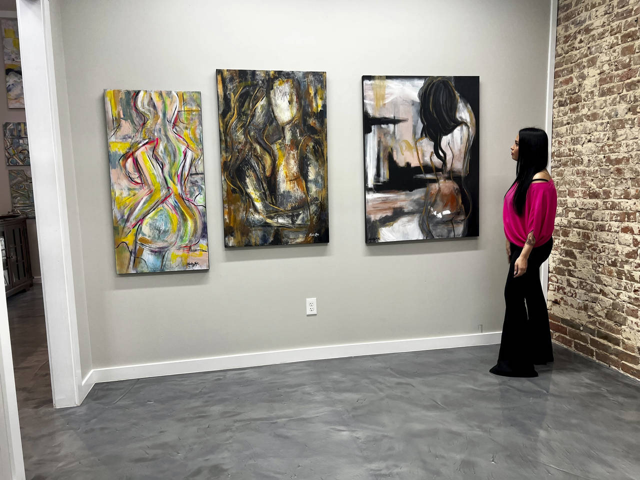 Louisiana artist Mandy Poche stands by paintings at her gallery in Ponchatoula, La., Nov. 1, 2022. ...