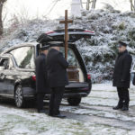 
              Pallbearers stand by the vehicle carrying the coffin of Boguslaw Wos, one of two Polish men killed in a missile explosion ahead of his funeral, in Przewodow, Poland, Saturday, Nov. 19, 2022. The deaths were likely the result of a Ukrainian air defense missile that went astray as the country was defending itself against a barrage of Russian missiles directed at Ukraine’s power infrastructure. (AP Photo)
            