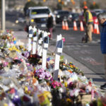 
              A lone visitor looks over the makeshift memorial near the scene of a mass shooting at a gay nightclub Wednesday, Nov. 23, 2022, in Colorado Springs, Colo.  The alleged shooter facing possible hate crime charges in the fatal shooting of five people at a Colorado Springs gay nightclub is scheduled to make their first court appearance Wednesday from jail after being released from the hospital a day earlier.  (AP Photo/David Zalubowski)
            