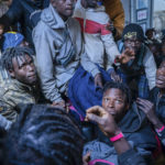 
              Migrants on the deck of the Rise Above rescue ship run by the German organization Mission Lifeline, in the Mediterranean Sea off the coasts of Sicily, southern Italy, Sunday, Nov. 6, 2022. Italy allowed one rescue ship, the German run Humanity 1, to enter the Sicilian port and begin disembarking minors, but refused to respond to requests for safe harbor from three other ships carrying 900 more people in nearby waters. (Severine Kpoti/Mission Lifeline Via AP)
            