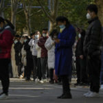 
              People wearing face masks stand in line for their routine COVID-19 tests at a coronavirus testing site in Beijing, Tuesday, Nov. 15, 2022. China's ruling party called for strict adherence to the hard-line "zero-COVID" policy Tuesday in an apparent attempt to guide public perceptions after regulations were eased slightly in places. (AP Photo/Andy Wong)
            