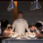 
              This image released by Searchlight Pictures shows Ralph Fiennes, center, in a scene from the film "The Menu." (Eric Zachanowich/Searchlight Pictures via AP)
            