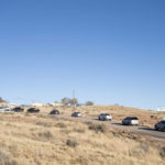 
              A line of cars forms at the Churchrock Chapter House in Church Rock, N.M., as voters arrive to place their ballots Tuesday, Nov. 8, 2022. Navajo voters are deciding who they want to be their next president, a position that wields influence nationally because of the tribe's hefty population and the size of it reservation in the U.S. Southwest. (AP Photo/William C. Weaver IV)
            