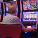 
              A gambler plays a slot machine at the Hard Rock Casino in Atlantic City, N.J., on Aug. 8, 2022. Figures released on Nov. 9, 2022, by the American Gaming Association show the U.S. commercial casino industry had its best quarter ever, winning over $15 billion from gamblers in the third quarter of this year. (AP Photo/Wayne Parry)
            