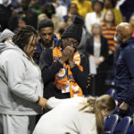 
              A family member of a shooting victim mourns during a memorial service in Charlottesville, Va., Saturday, Nov. 19, 2022. Over a thousand students and locals attended the service at John Paul Jones Arena to honor three student football players who were killed on Sunday, Nov. 13, 2022. (Mike Kropf/The Daily Progress via AP)
            