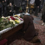 
              Relatives, friends, and comrades mourn next to the coffin of Ukrainian serviceman Sergii Myronov, killed fighting Russian troops in Donetsk region, during a funeral ceremony at St. Michael's Golden-Domed Monastery in Kyiv, Ukraine, Wednesday, Nov. 23, 2022. (AP Photo/Andrew Kravchenko)
            