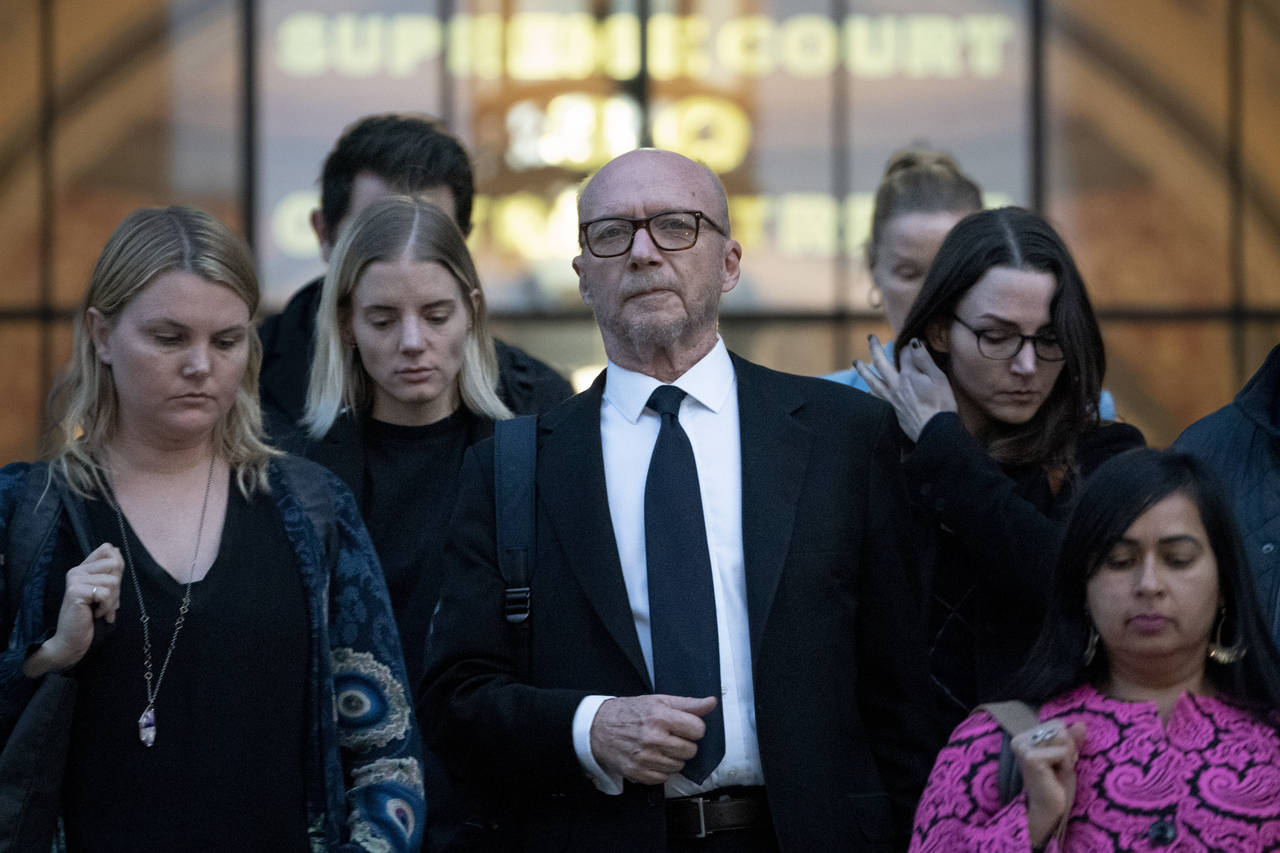 Screenwriter and film director Paul Haggis, center, leaves court after being found guilty in a sexu...