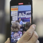 
              A member of the crowd films Texas Governor Greg Abbott at a rally Friday, Nov. 4, 2022 at Michael's Charcoal Grill in Midland, Texas. (Michael Bauer/Odessa American via AP)
            