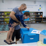 
              A man and his son vote during Israeli elections in Tel Aviv, Israel, Tuesday, Nov 1, 2022. (AP Photo/Oded Balilty)
            