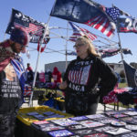 
              Vendors display merchandise for sale before former President Donald Trump speaks at a rally in support of the campaign of Ohio Senate candidate JD Vance at Wright Bros. Aero Inc. at Dayton International Airport on Monday, Nov. 7, 2022, in Vandalia, Ohio. (AP Photo/Michael Conroy)
            