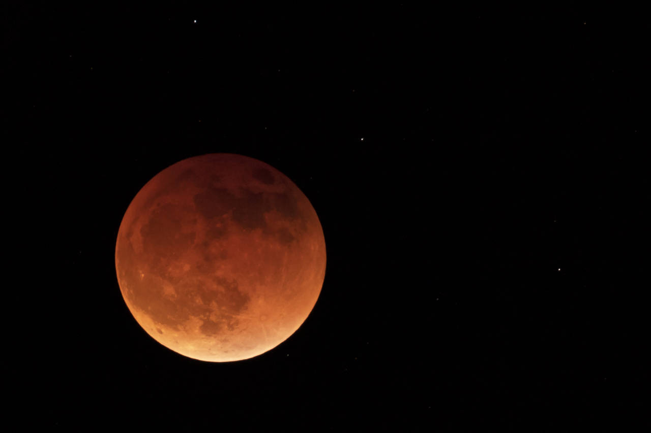 FILE - The moon is shown during a full lunar eclipse, Sunday, May 15, 2022, near Moscow, Idaho, wit...