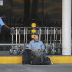 
              A man waits with his luggage at Jomo Kenyatta International Airport in Nairobi, Kenya Monday, Nov. 7, 2022. Pilots working for Kenya's national airline Kenya Airways have been on strike for three days over a demand to honor a retirement savings plan, and it is estimated to be costing millions of dollars in losses daily. (AP Photo/Brian Inganga)
            
