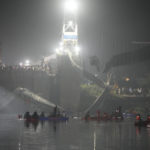 
              FILE - Rescuers in boats search  the Machchu river next to a cable suspension bridge that collapsed in Morbi town of western state Gujarat, India, Monday, Oct. 31, 2022. More than 400 people died in October in a series of crowd-related disasters in Asia that could have been prevented if authorities had acted differently. (AP Photo/Ajit Solanki, File)
            