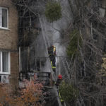 
              Ukrainian State Emergency Service firefighters work to extinguish a fire at the scene of a Russian shelling in Kyiv, Ukraine, Tuesday, Nov. 15, 2022. Strikes hit residential buildings in the heart of Ukraine's capital Tuesday, authorities said. Further south, officials announced probes of alleged Russian abuses in the newly retaken city of Kherson, including torture sites and enforced disappearances and detentions. (AP Photo/Andrew Kravchenko)
            