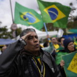 
              A supporter of Brazilian President Jair Bolsonaro salutes while singing the nation's anthem outside a military base during a protest against his reelection defeat in Sao Paulo, Brazil, Thursday, Nov. 3, 2022. Some supporters are calling on the military to keep Bolsonaro in power, even as his administration signaled a willingness to hand over the reins to his rival, President-elect Luiz Inacio Lula da Silva. (AP Photo/Matias Delacroix)
            