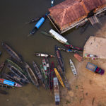 
              Moored boats, some with people sit at the port of Carauari city, Amazonia, Brazil, Thursday, Sept. 1, 2022. Pirarucu fishing is done once a year, around September, the period of lowest water.  (AP Photo/Jorge Saenz)
            